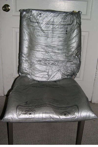 Profile view of the chair with me sitting in it, demonstrating conformation of foam-in-place cells to body contours.